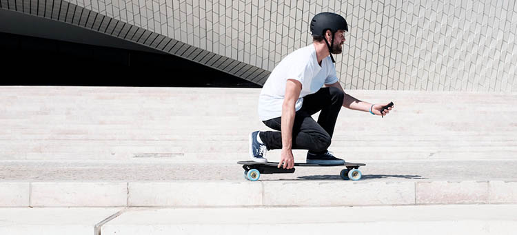 man riding a diy electric skateboard