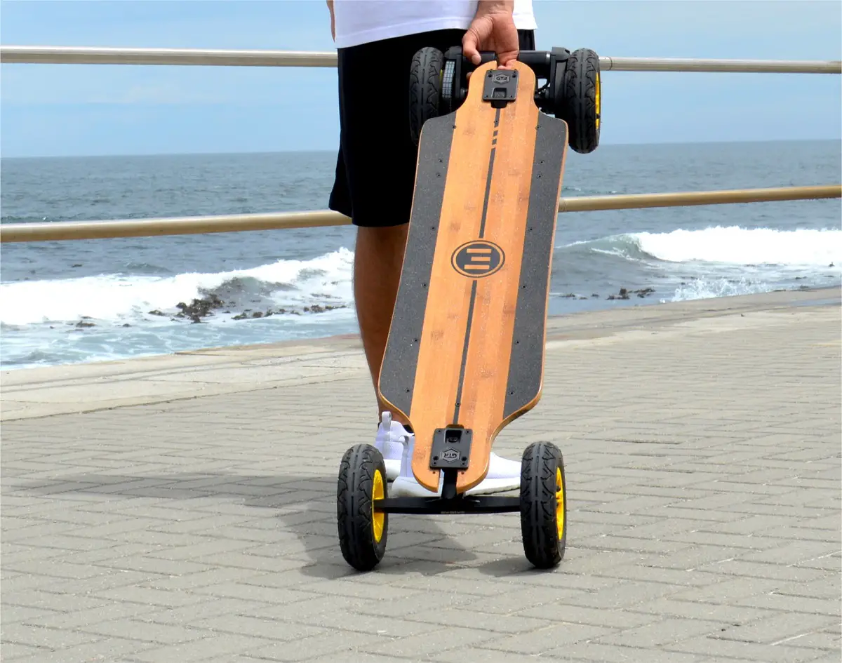 person holding electric skateboard