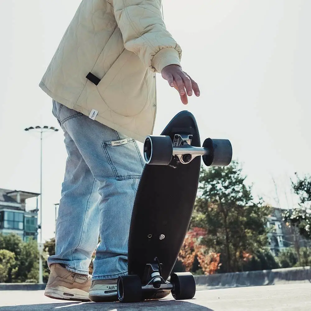 man holding MAXFIND MAX ONE - Best Electric Skateboards for Kids