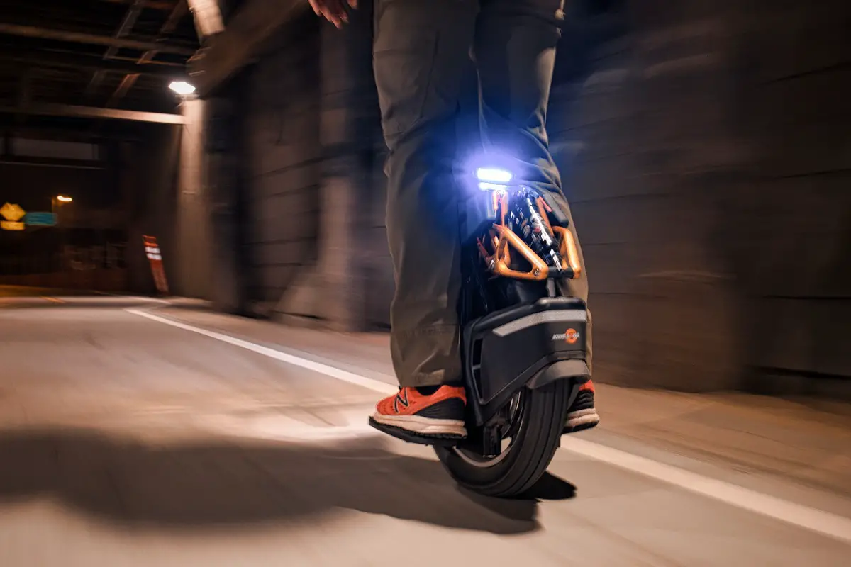 person riding an electric unicycle during the night