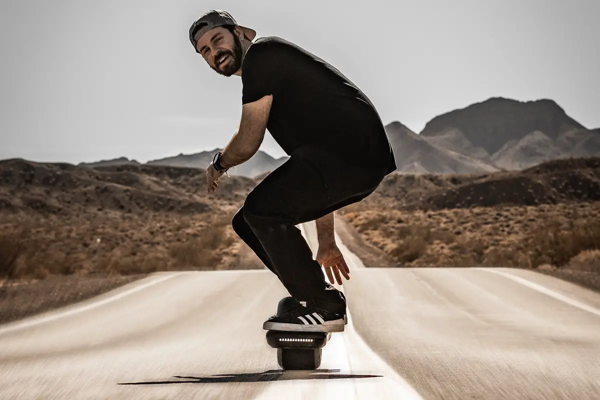 man riding a onewheel on the road