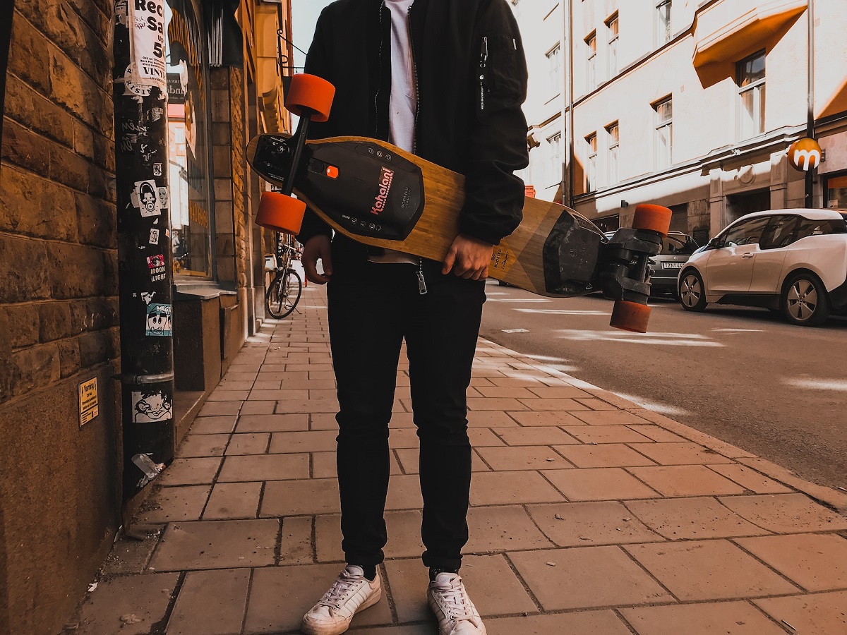 man holding boosted board