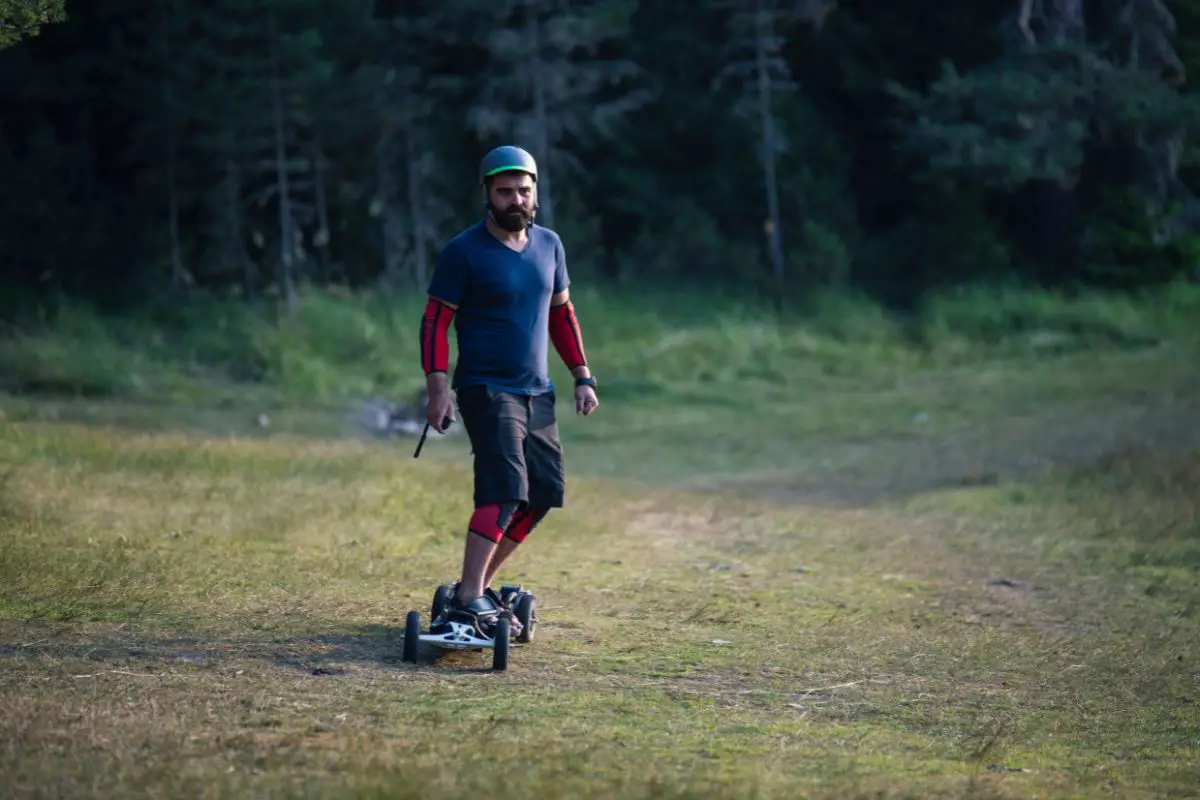 man riding off-road boosted board