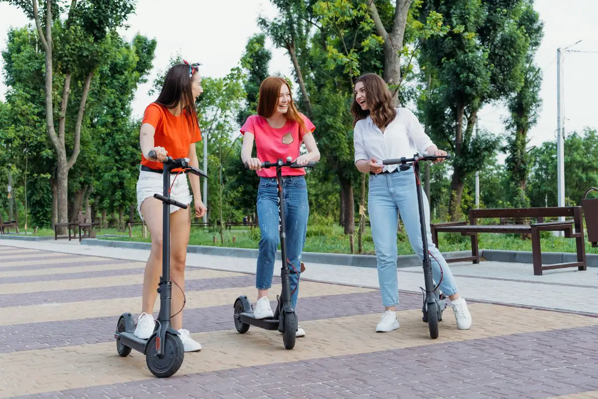 friends using adult ride-on toys e-scooters