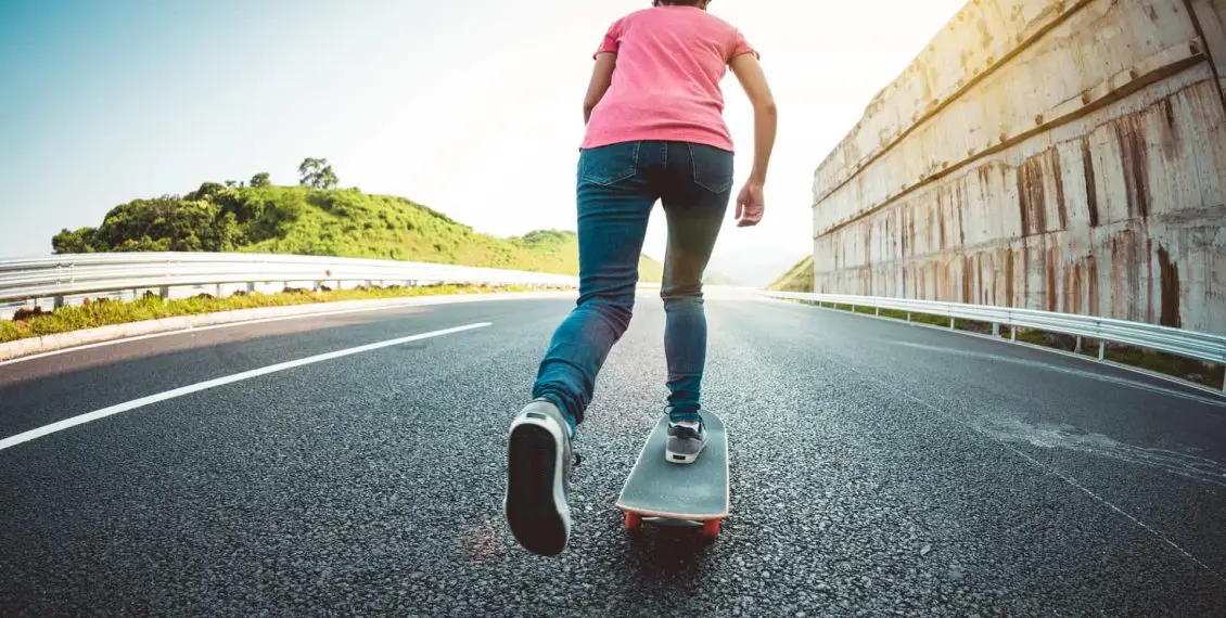 Skateboarder skateboarding on highway road